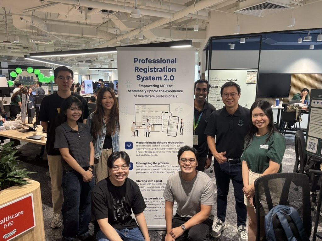 The PRS 2.0 team standing around the project's poster in the GovTech office