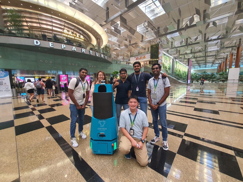 The GovTech robotics team posing with one of their robots